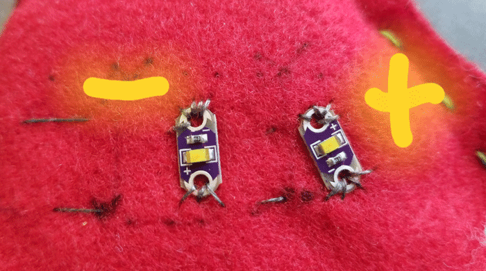 Two LEDs sewn in parallel with the positive side sewn to the negative side of the other